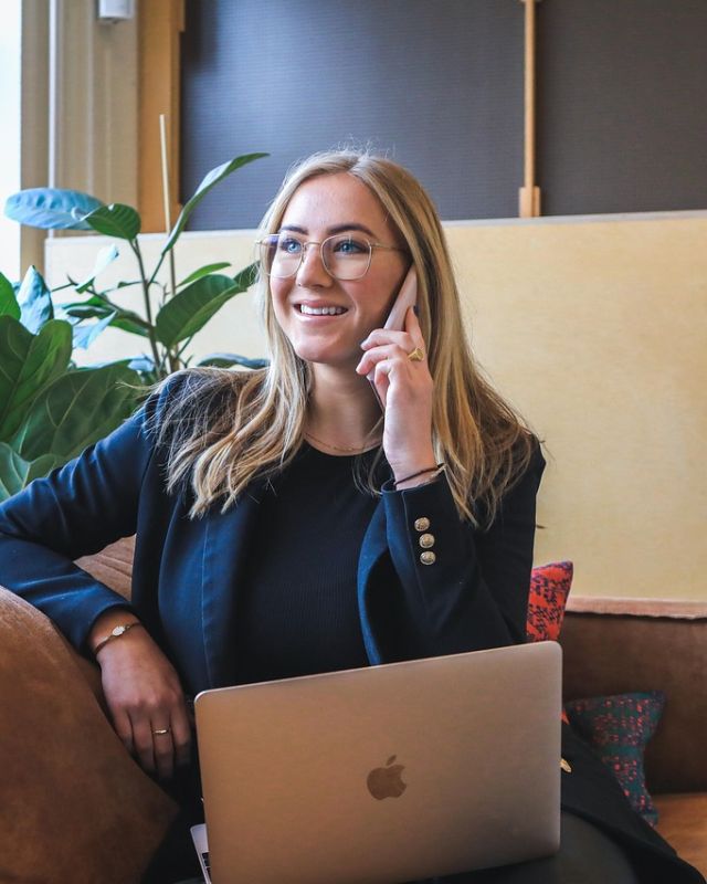 A woman on a phone call in a bright office